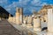 State Agora columns in ancient Ephesus with Odeon ruins in background