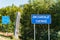 State border between Norway and Sweden in Northern Sweden, mountains in Lappland. Mile stone with Swedish text and blue road sign