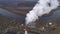 State district power station aerial view. Steam comes from a high factory chimney.