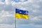 State flag of Ukraine in a peaceful sky. Yellow and blue symbol of freedom, patriotism and unbowed