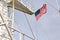 State flags raised on the mast of a merchant ship in the ports of call.
