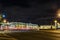 The State Hermitage Museum at night lights against background of traces of headlights of passing cars, Saint-Petersburg