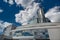 State Institution `National Library Of Belarus`, Futuristic Back View With Reflections Of Blue Sky And White Clouds. One Of The M