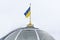 State symbols of Ukraine. Flag of Ukraine on a flagpole over the parliament building, the Verkhovna Rada