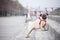 A stately dog pug in a red collar stands on stone steps