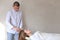 Stately male male cosmetologist makes head massage with special