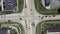 Static aerial establishing shot of intersection in the American suburbs. Traffic signal light, cars stopped at light,