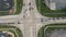 Static aerial establishing shot of intersection in the American suburbs. Traffic signal light, cars stopped at light, traffic driv