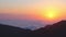 Static aerial panoramic view of sun rising above horizon with clouds above forest. Weather and forecast background