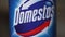 Static close-up of Domestos bleach bottle label.