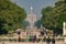 Static long shot looking through Tuileries Garden in Paris in springtime.  The Luxor Obelisk and Arc De Triomphe are in the