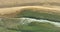 Static top down view of tropical beach, foamy ocean waves washing sand. Waves hitting sand beach