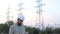 Station technical director with working drawings at nuclear power station. Worker in white helmet with engineering