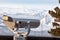Stationary binoculars on the observation deck in the Altai mountains in winter with snow and beautiful scenery. Rest and travel
