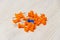 Stationary, Orange, Blue Pushpins Heap on White Wooden Background, Concept for Difference, Individuality.