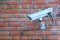 Stationary outdoor video camera on a brick wall