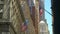 A stationary shot of USA flags flying on Wall Street