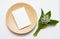 Stationary still life scene of Blank invitation or greeting card, Bamboo plate and lily of the valley flowers. Mockup