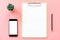 Stationery, blank clipboard, smartphone, pot plant on pink pastel color with copy space for background