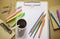 Stationery: clipboard, clips, pencils, color pens, paintbrush,.