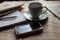 Stationery with newspapers, smartphone and cup of cofee