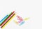 Stationery office supplies, Colored pencils with colorful clips on white background