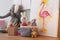 Stationery, picture and toys on wooden table in children`s room. Interior design