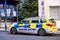 Stationery Police Squad Car Parked At A Bus Stop