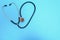 statoscope closeup on blue background, top view.Global healthcare concept.Statoscope stylish doctor with heart on blue