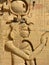Statue of the ancient Egyptian goddess Isis with nesting birds in relief