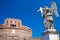 Statue of Angel with the cross and Castel Saint Angelo on the background. Rome. Italy.