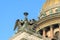 Statue of angels on the roof of Saint Isaac`s Cathedral in winter. Saint Petersburg. Russia