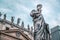 Statue of Apostle Peter in front of St Peter`s Basilica, Rome, Italy. Renaissance sculpture of apostle with key on dramatic sky