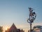 Statue of Archangel Saint Michael slaying a dragon next to promenade of river Lys in Ghent, Belgium and at dusk