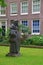 Statue of a Beguine in the beautiful courtyard of The Begijnhof at Amsterdam