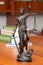 Statue of blindfolded Themis with a sword and scales