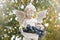 Statue of boy with angel wings holds juicy ripe blue grapes