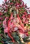 Statue of Brass Hindu Goddess Lakshmi (Maha Laxshmi) is decorated with flowers garland and Bouquet of Pink Lotus