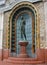Statue of bronze woman in a ceramic niche of the Gellert baths in Budapest