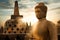 Statue of Buddha against the background of the sunrise with rays of light in the Borobudur Temple. Java island. Indonesia. Famous