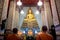The statue of buddha and the monk in chapel at wat arun temple
