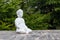 Statue of Buddha - peaceful mind. White deity on blur green background. Meditate concept