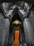 Statue of Buddha in shrine with incense, offerings