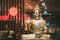 Statue Of Buddha Sitting In Lotus Position With Raised Right Arm