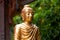 Statue of Buddha sitting meditating Mahayana gold on the outdoor