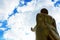 Statue of Buddha in standing posture with sky view