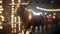 a statue of a bull is standing in front of a building with lights on it\\\'s sides and a string of ligh