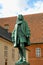 The statue of Chancellor Peder Griffenfeld and a tower in Copenhagen, Denmark