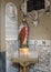 Statue of Christ and Finely carved tombstones decorating the wall at the entrance to San Lorenzo in Lucina