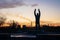 Statue of cosmonaut Yuri Gargarin with raised hands at Gagarin park at sunset